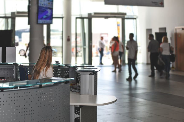 building reception with multiple people walking through