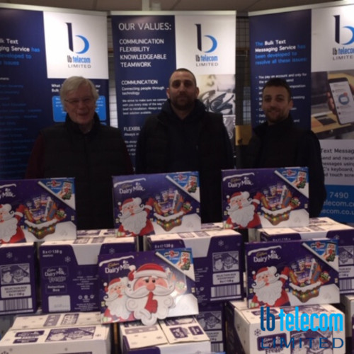 a group standing behind chocolate selection boxes